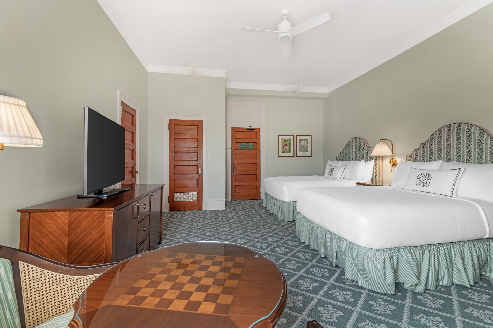 a room with two beds and a television