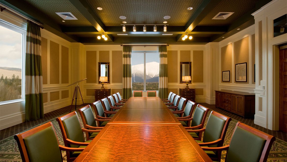 a conference room with a table and chairs