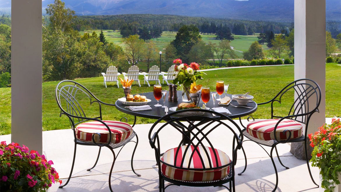 a table with drinks and chairs on a patio