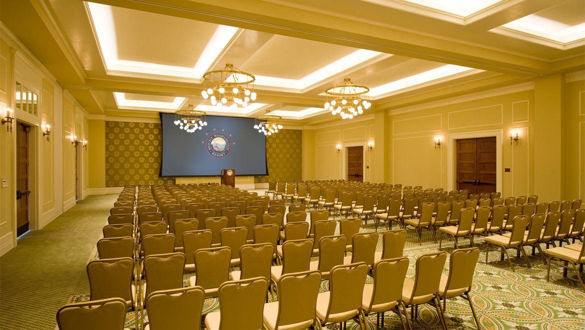 a large room with chairs and a projector screen