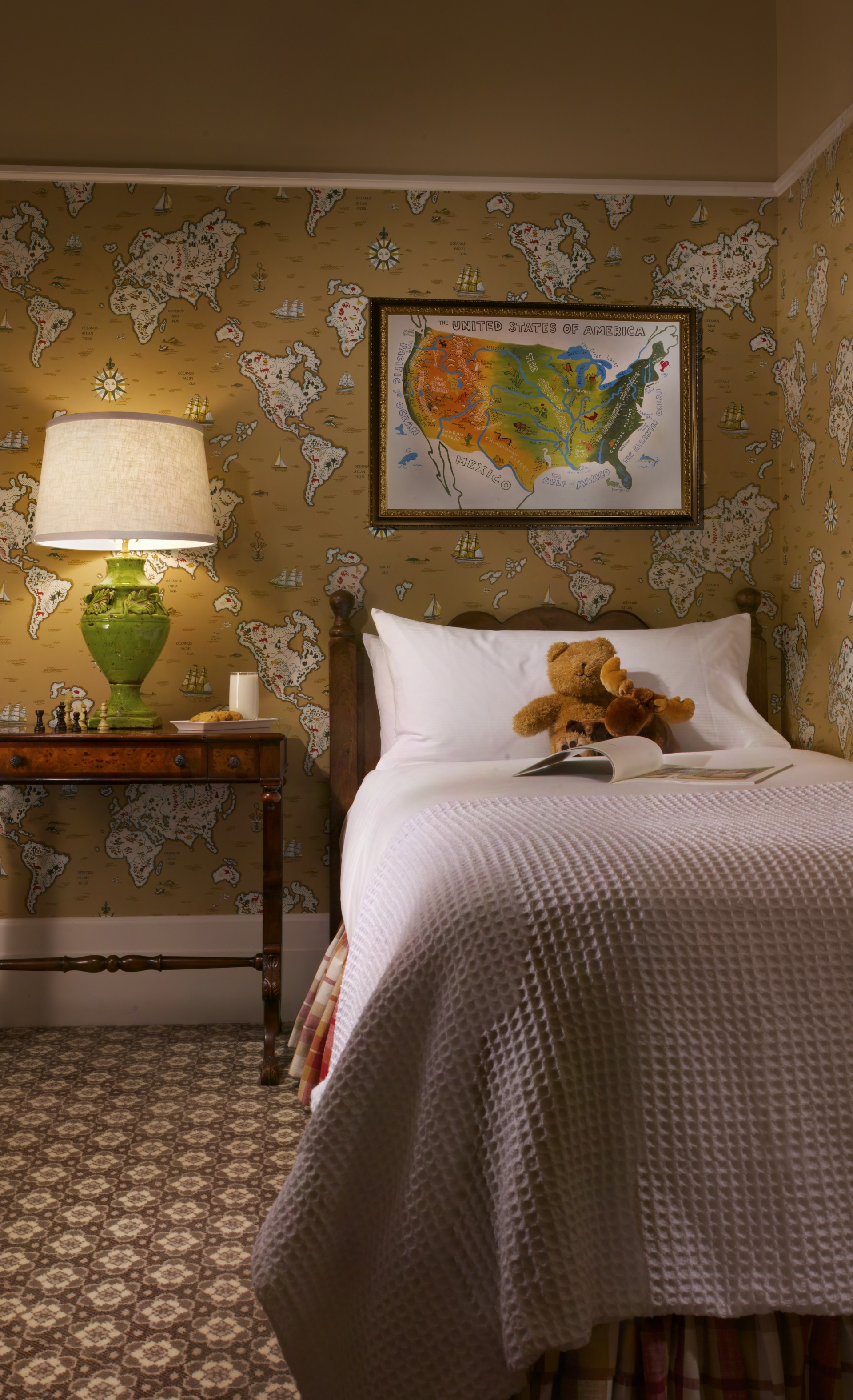 a bed with a teddy bear on it