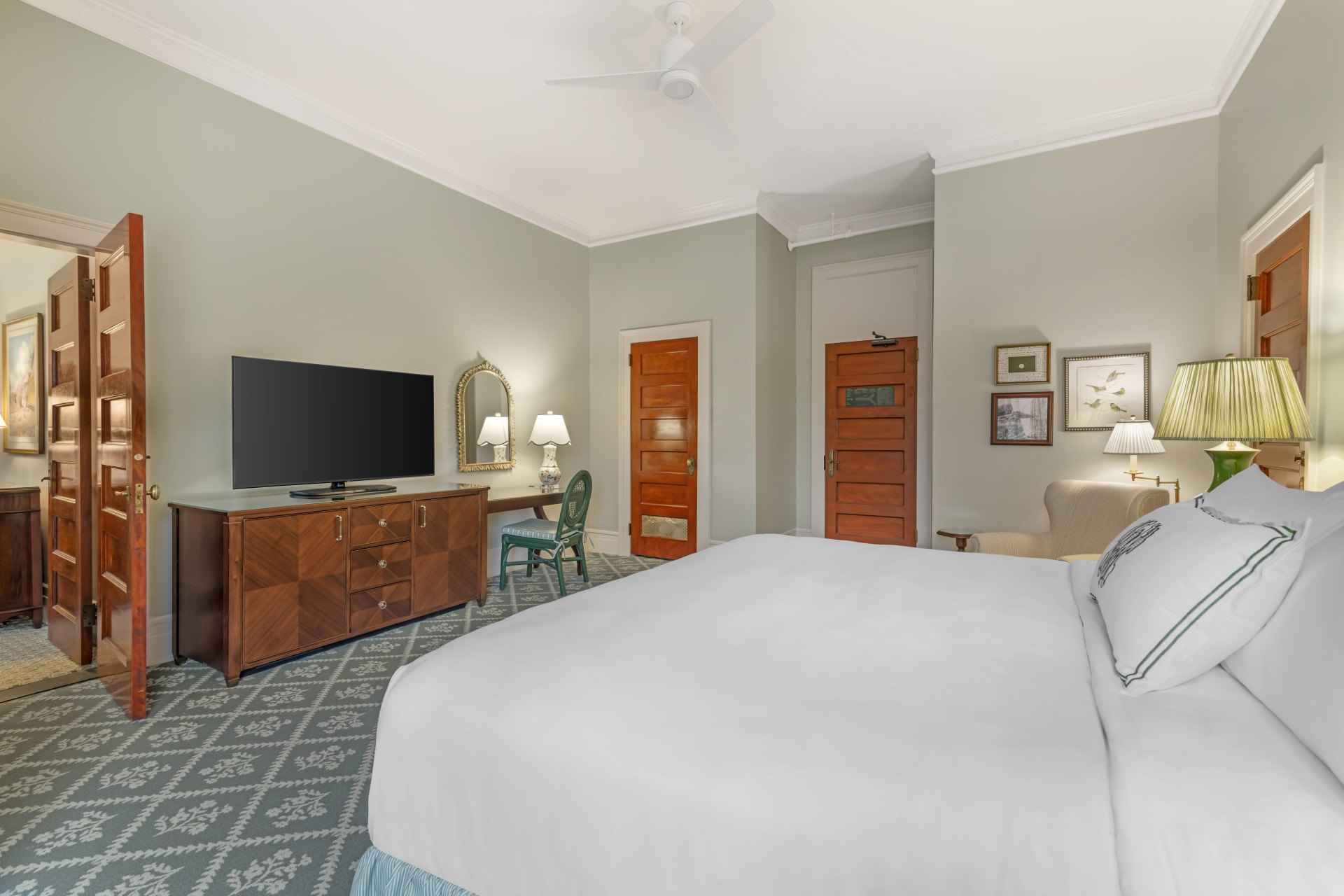 a bedroom with a large bed and a television