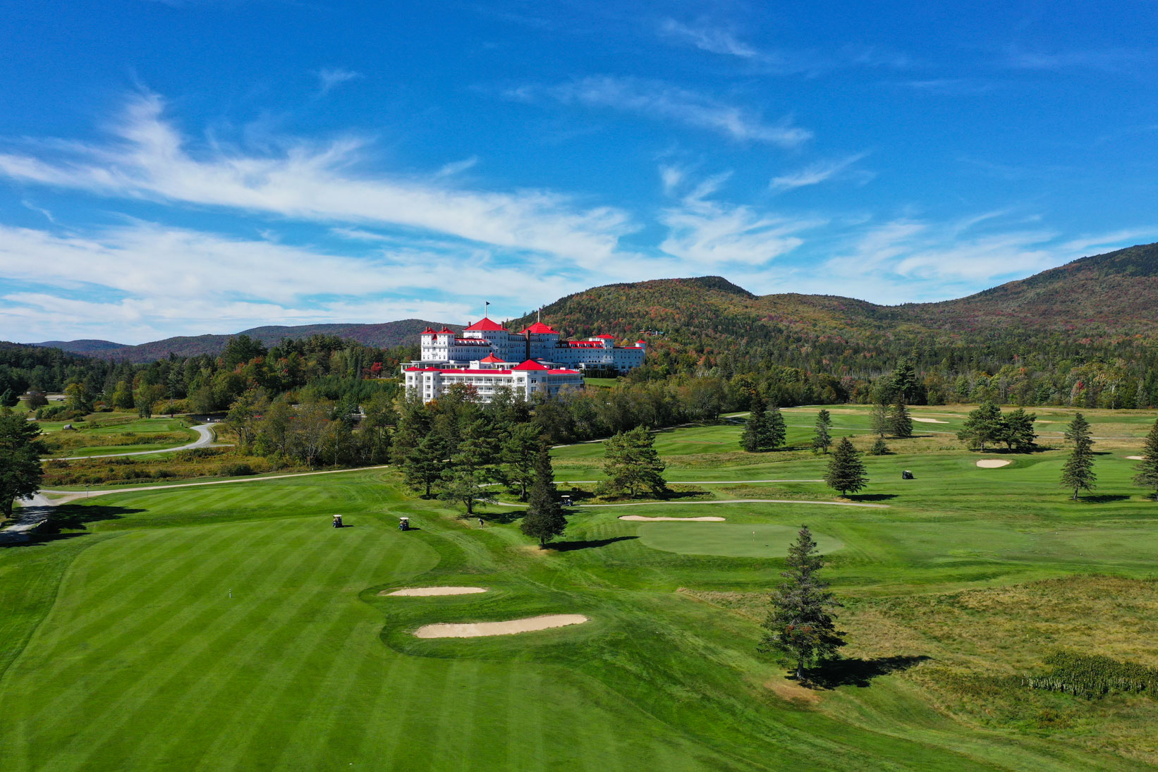 a golf course with a large building in the background
