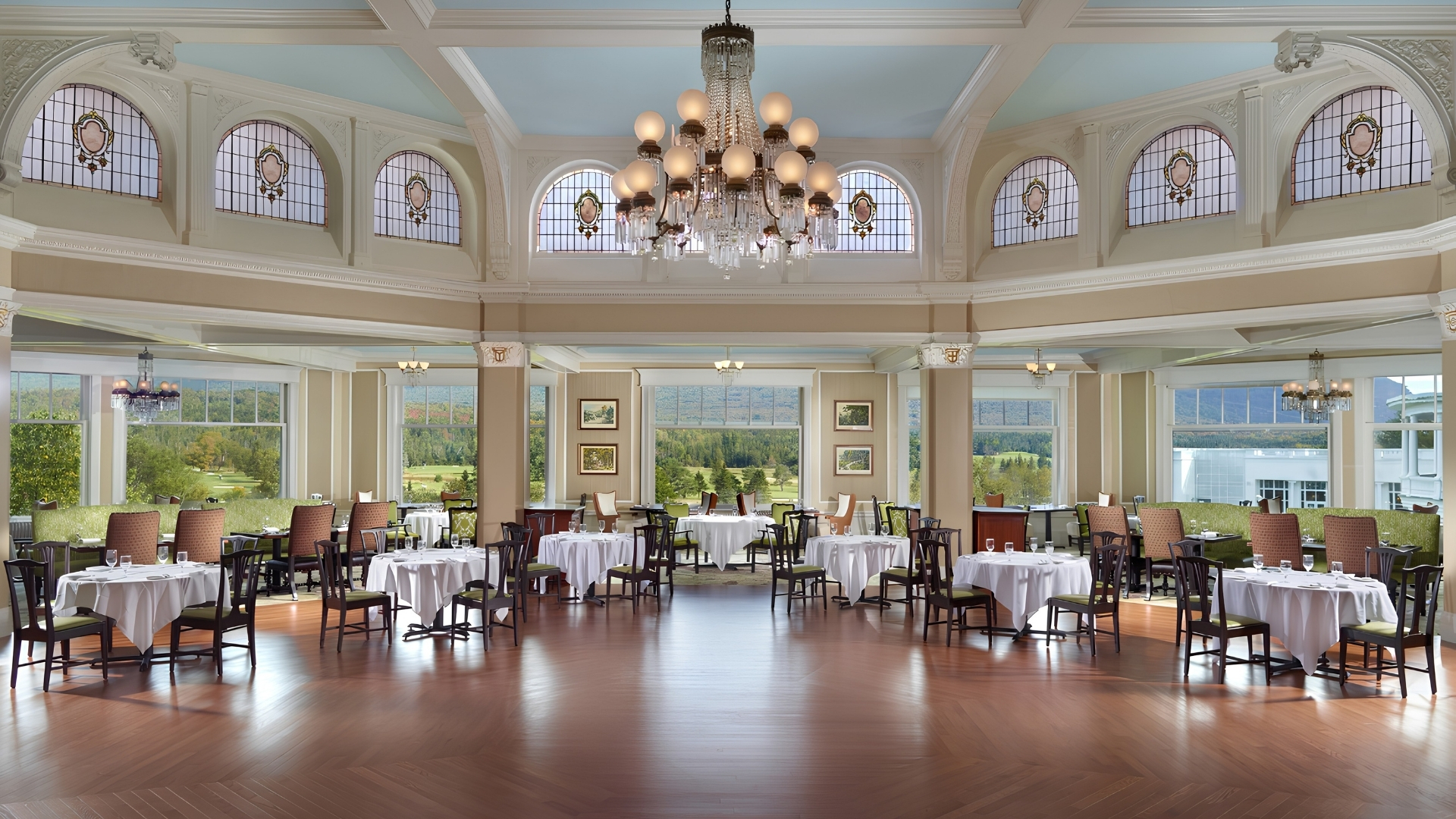a room with tables and chairs and a chandelier