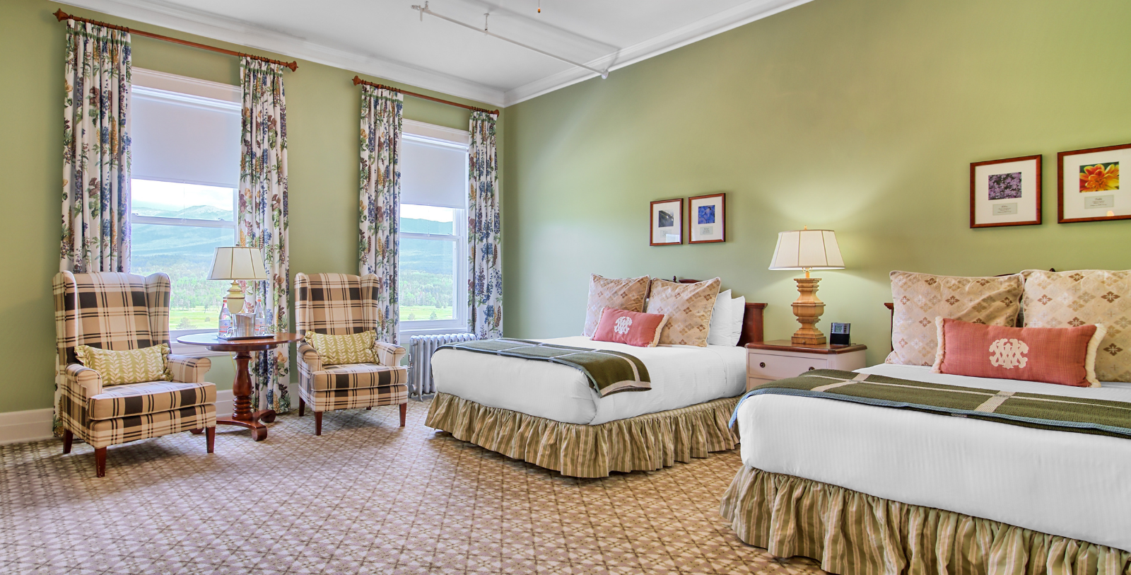 a room with two beds and a chair