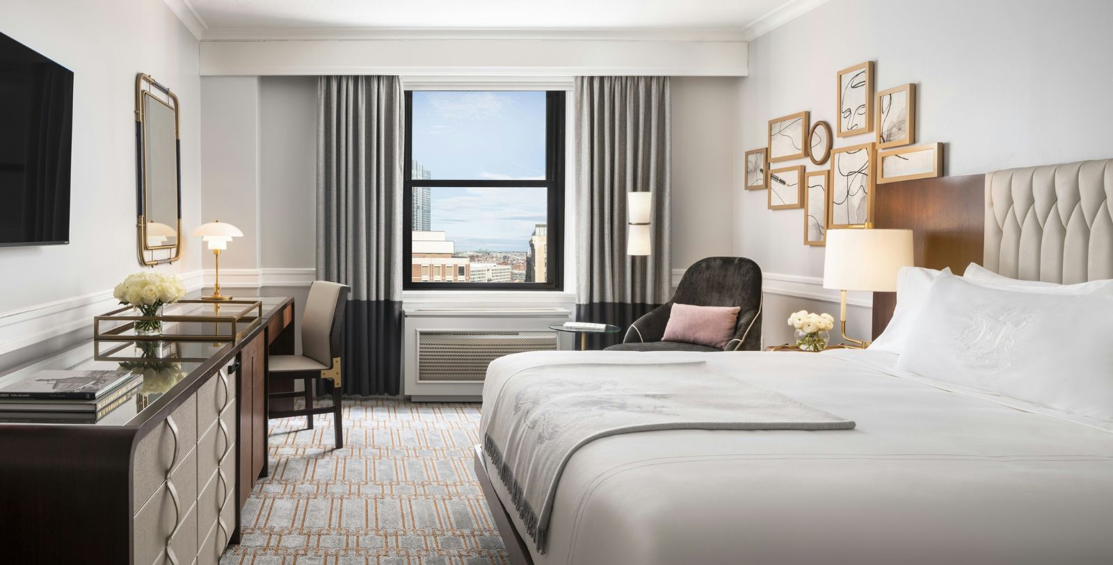 a room with a bed and a desk and chair