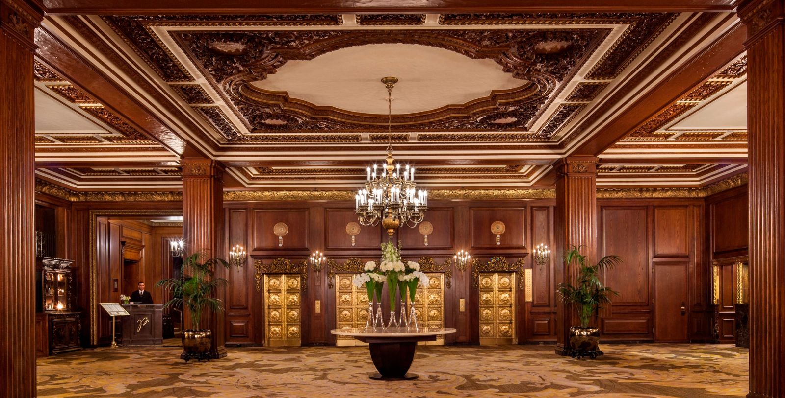 a room with a chandelier and flowers