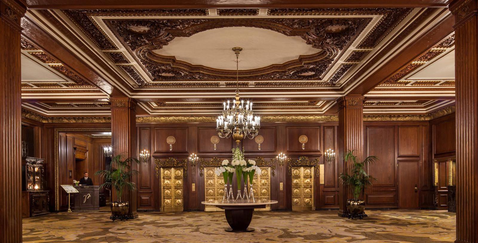 a room with a chandelier and flowers