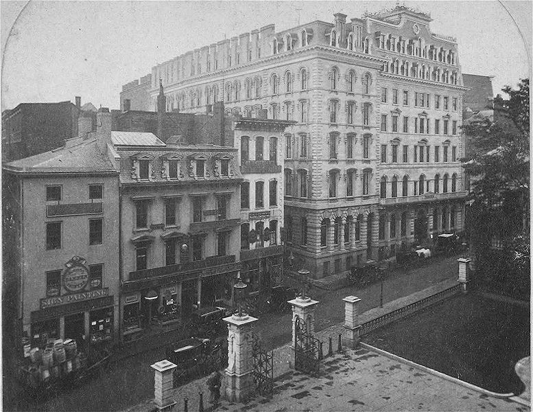 a black and white photo of a street with buildings