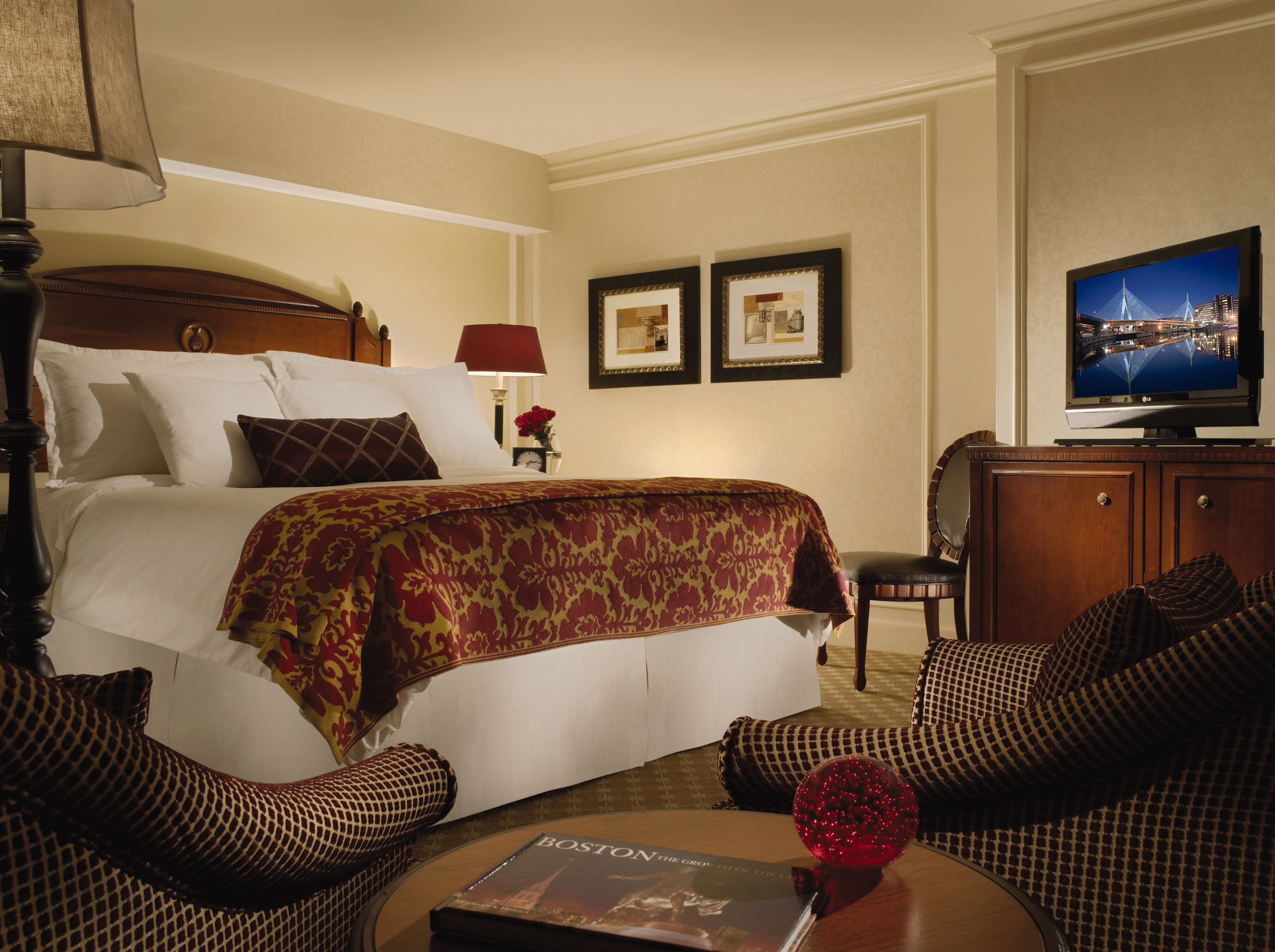 a hotel room with a bed and a television