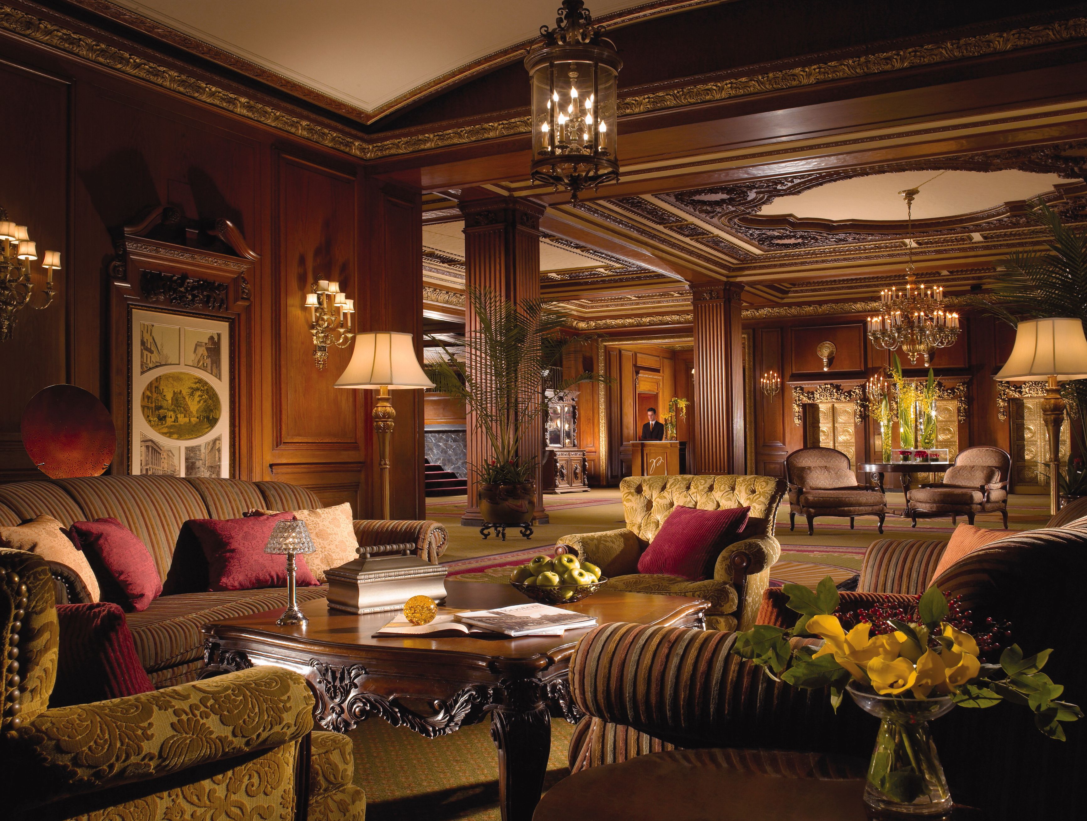 a room with a large chandelier and a large table
