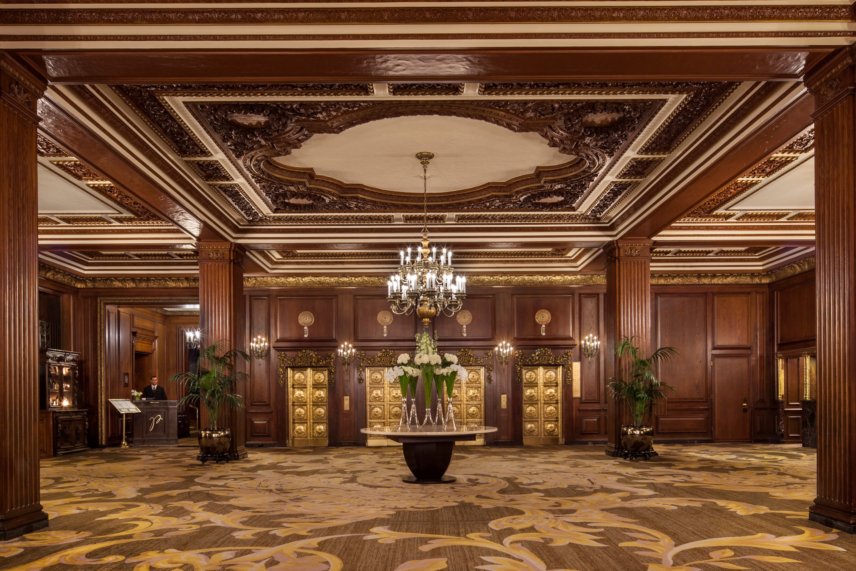 a large room with a chandelier and flowers