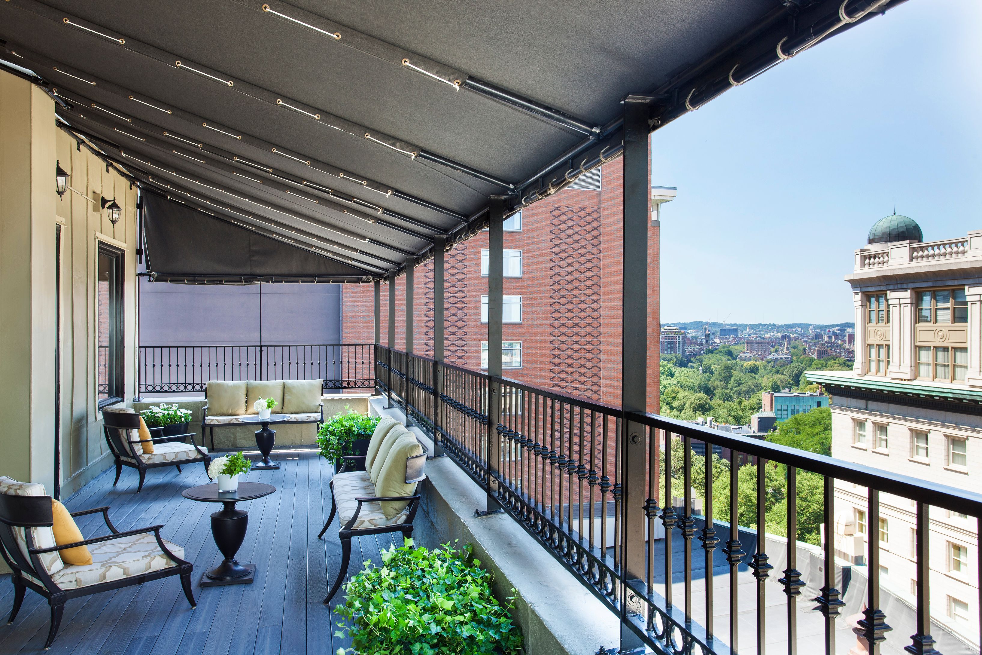 a patio with chairs and a railing