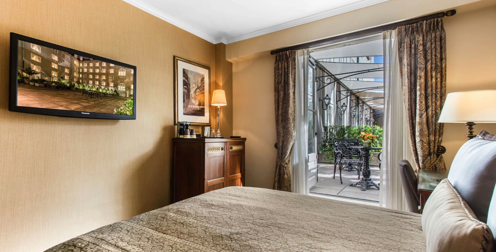 a room with a bed and a table and chairs
