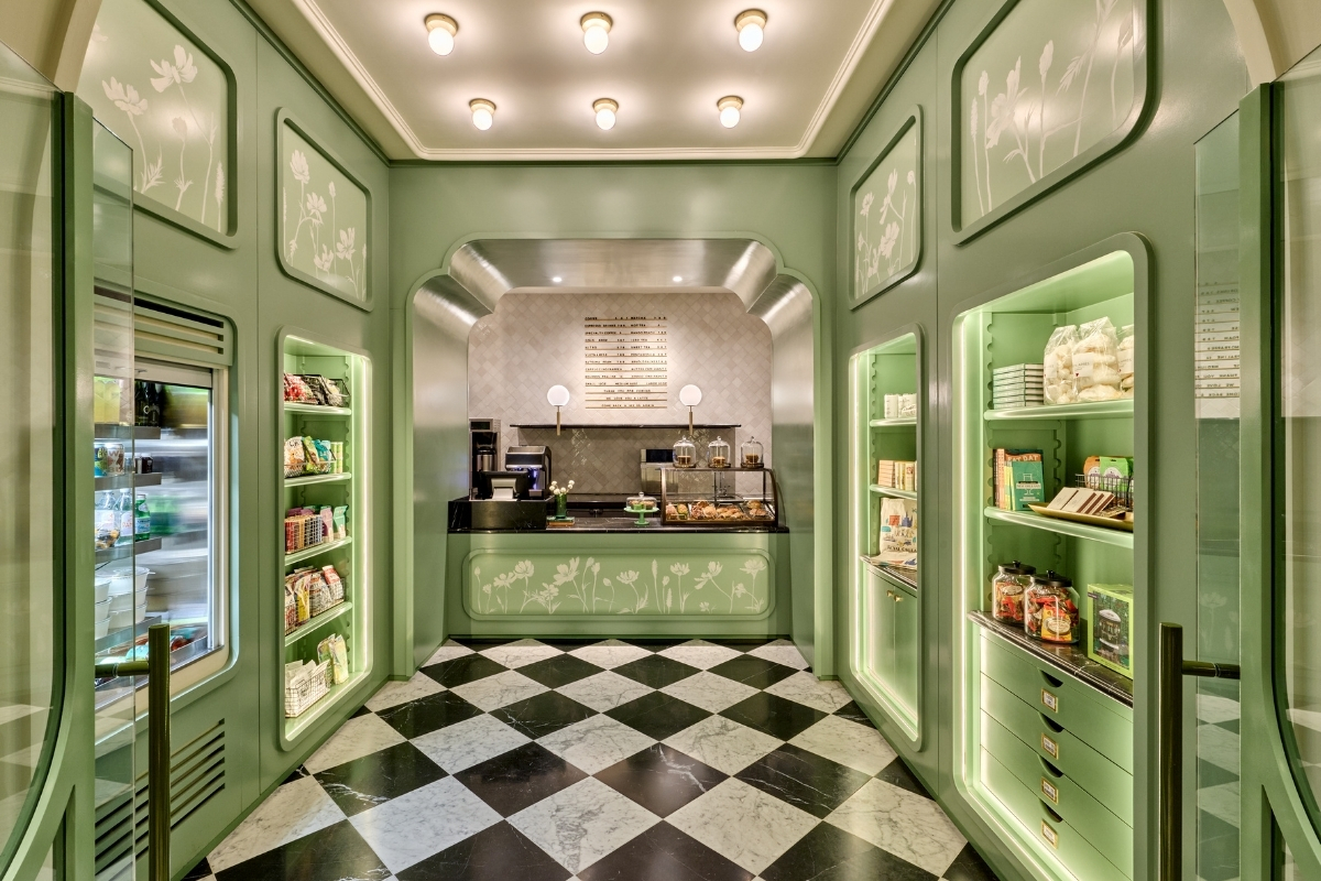 a green and white room with shelves and shelves