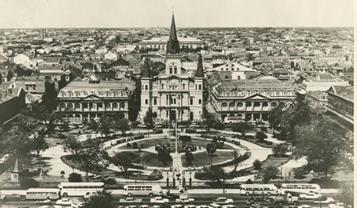 a large building with a spire in front of a large city