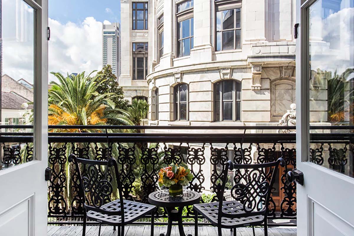 a balcony with a table and chairs