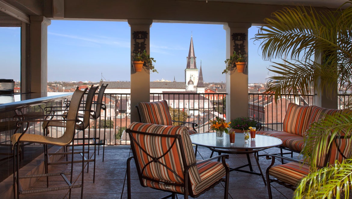 a patio with chairs and a table