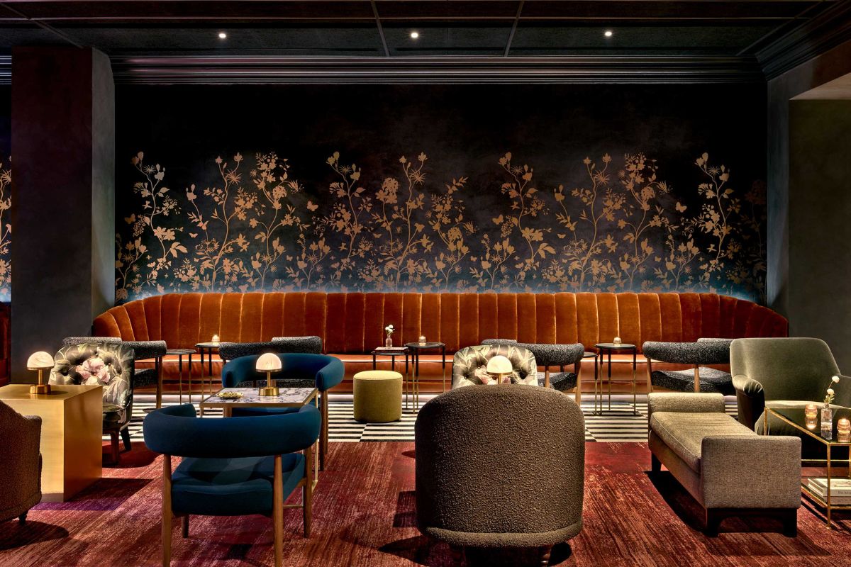 a room with a long booth and tables and chairs