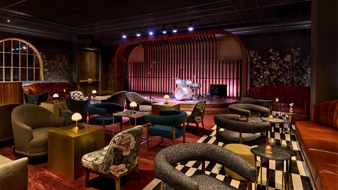 a room with a drum set and chairs
