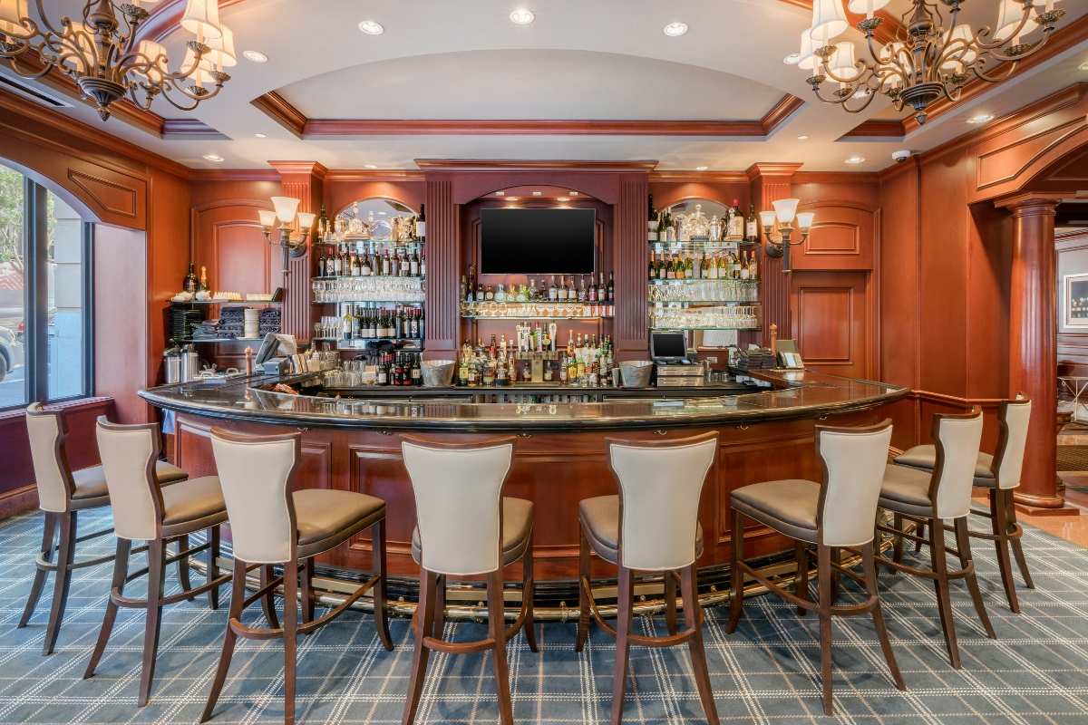 a bar with a counter and chairs