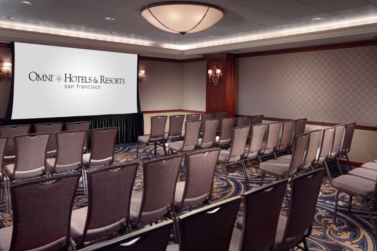 a room with chairs and a projector screen