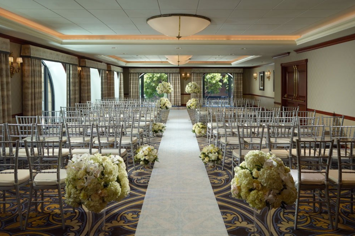 a room with chairs and flowers