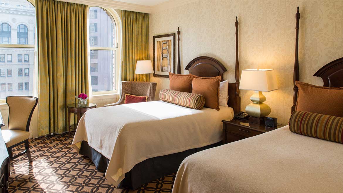 a room with two beds and a window