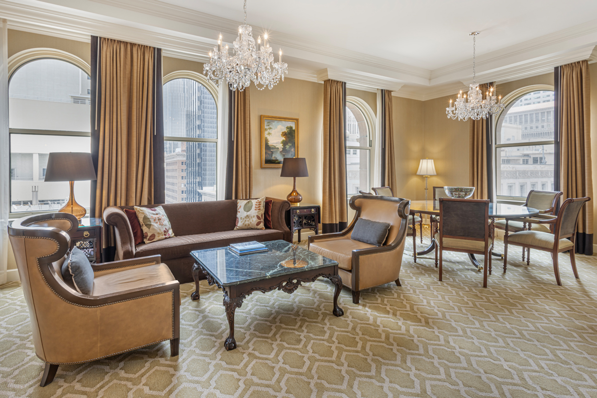 a living room with a chandelier and couches
