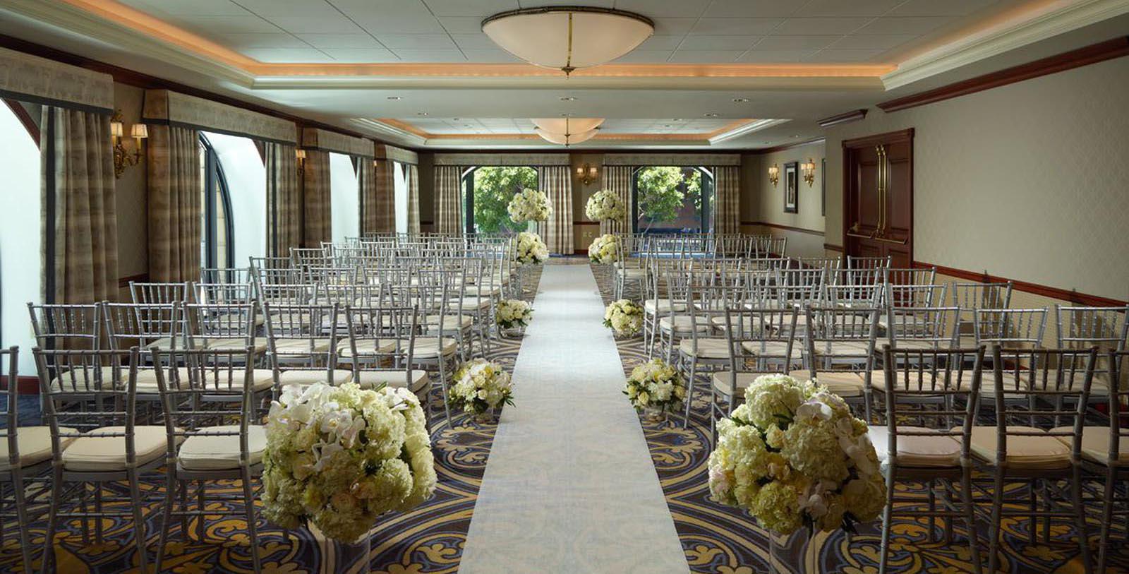 a room with chairs and flowers