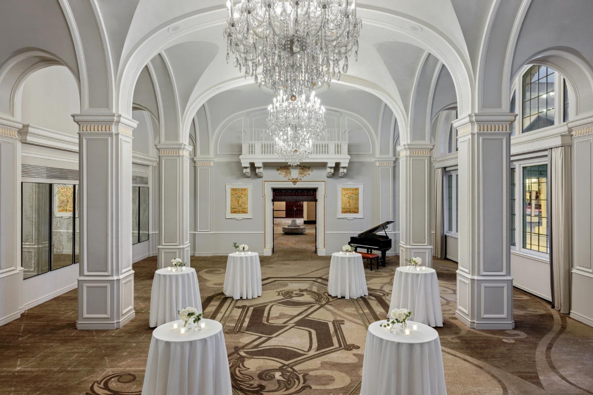 a room with tables and a chandelier