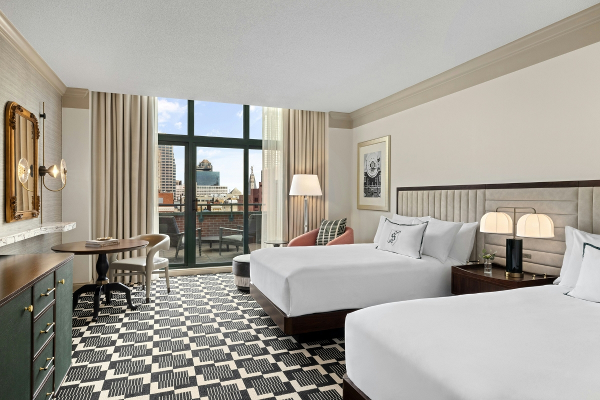 a room with two beds and a table
