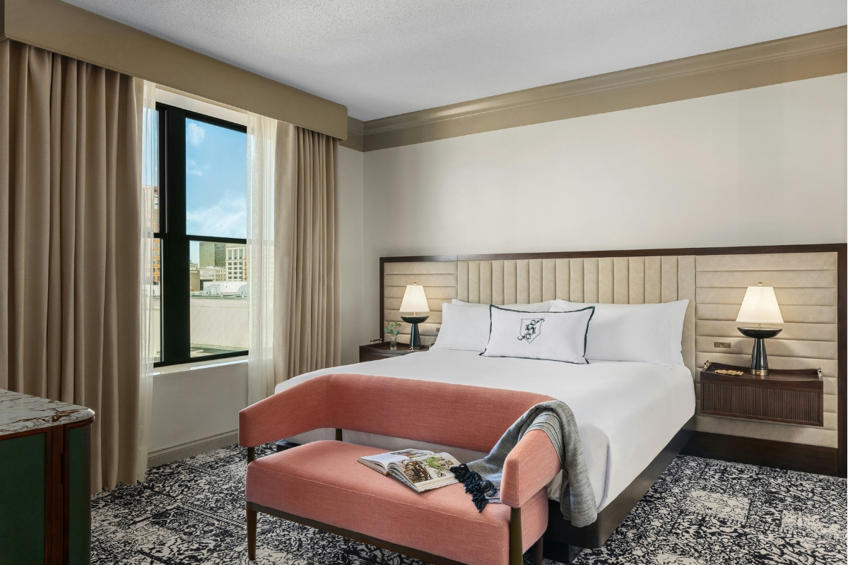a bedroom with a bed and a bench