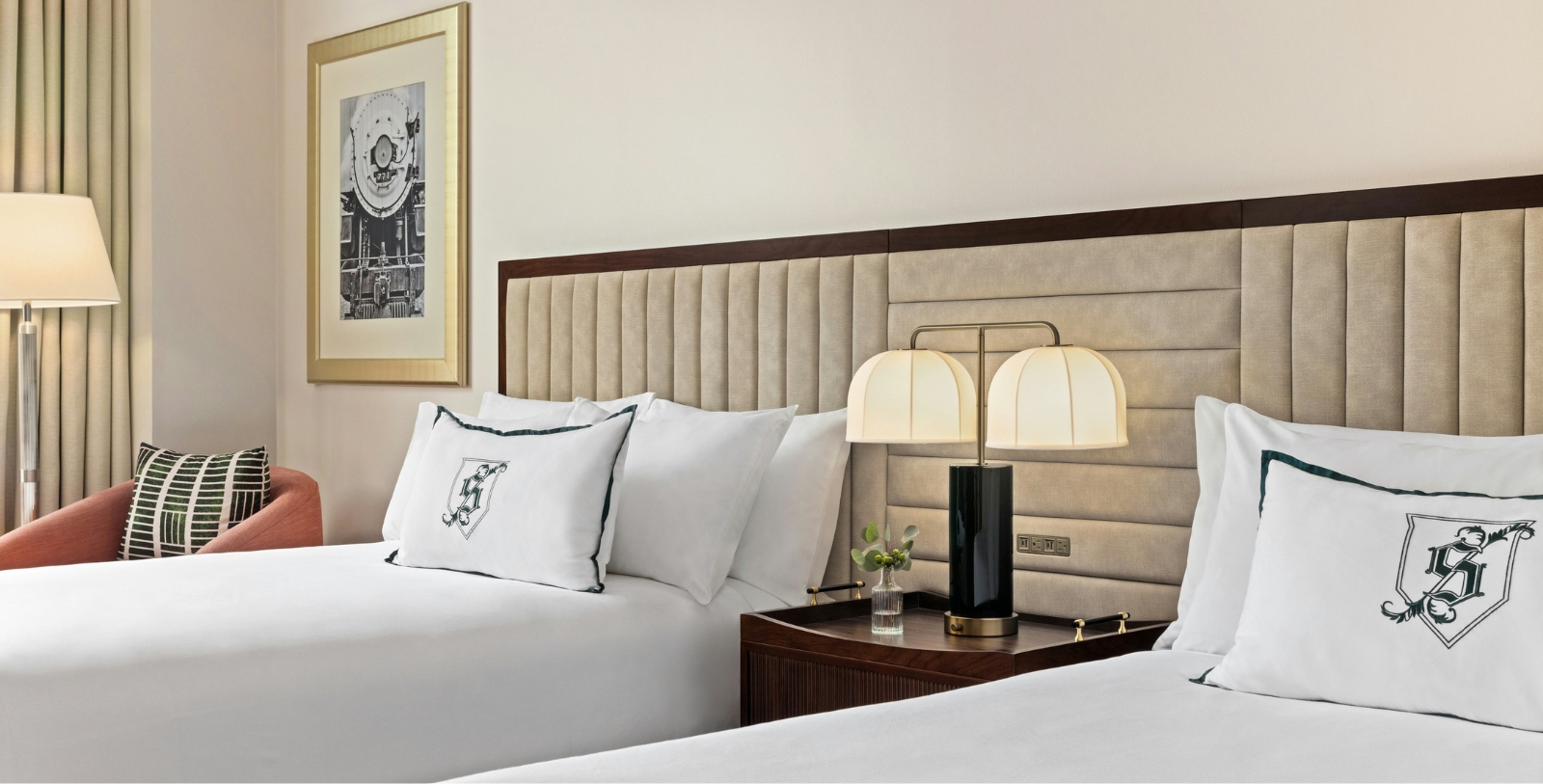 a bed with two lamps next to each other