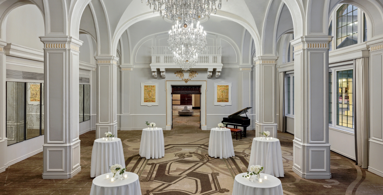 a room with tables and a piano