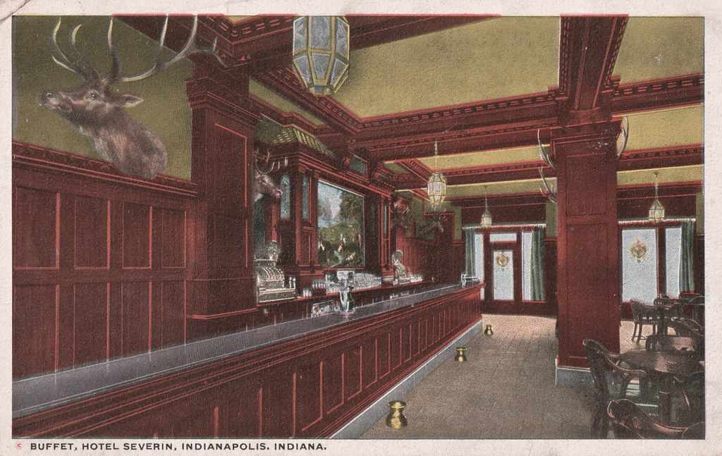 a bar with a mirror and a deer head