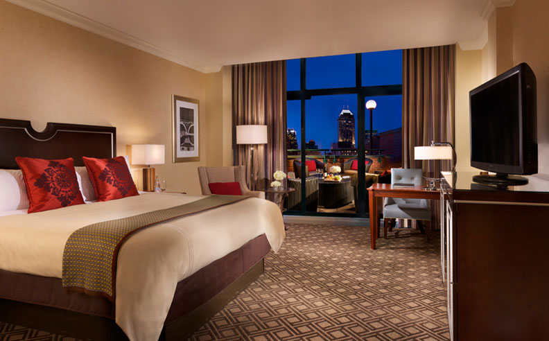 a hotel room with a bed and a desk