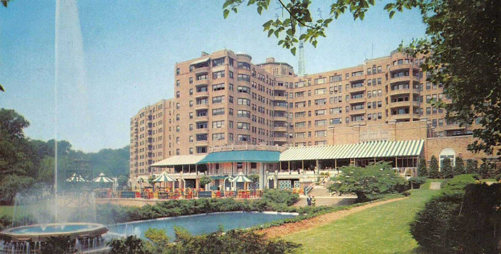 a large building with a pool in front