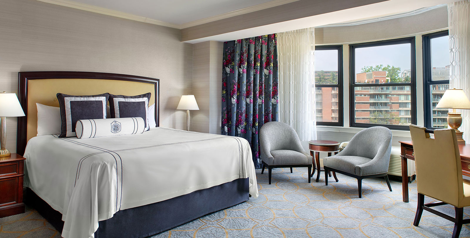a bedroom with a bed and chairs