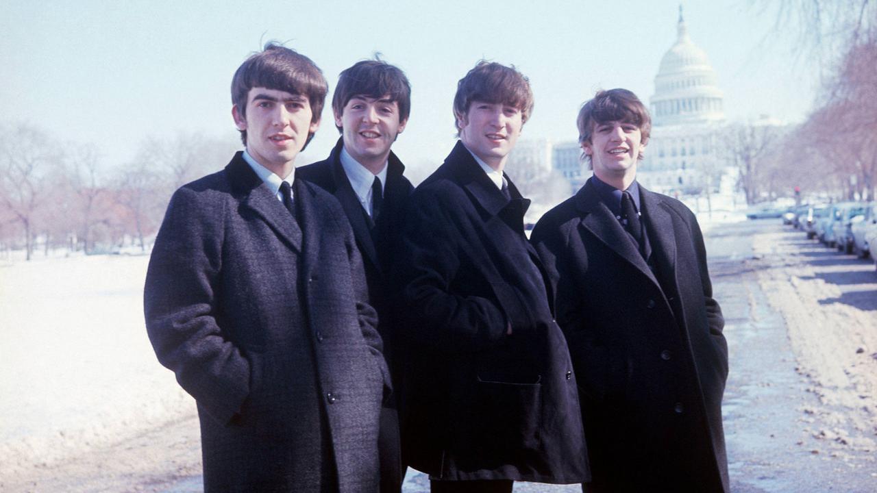 a group of men in black coats