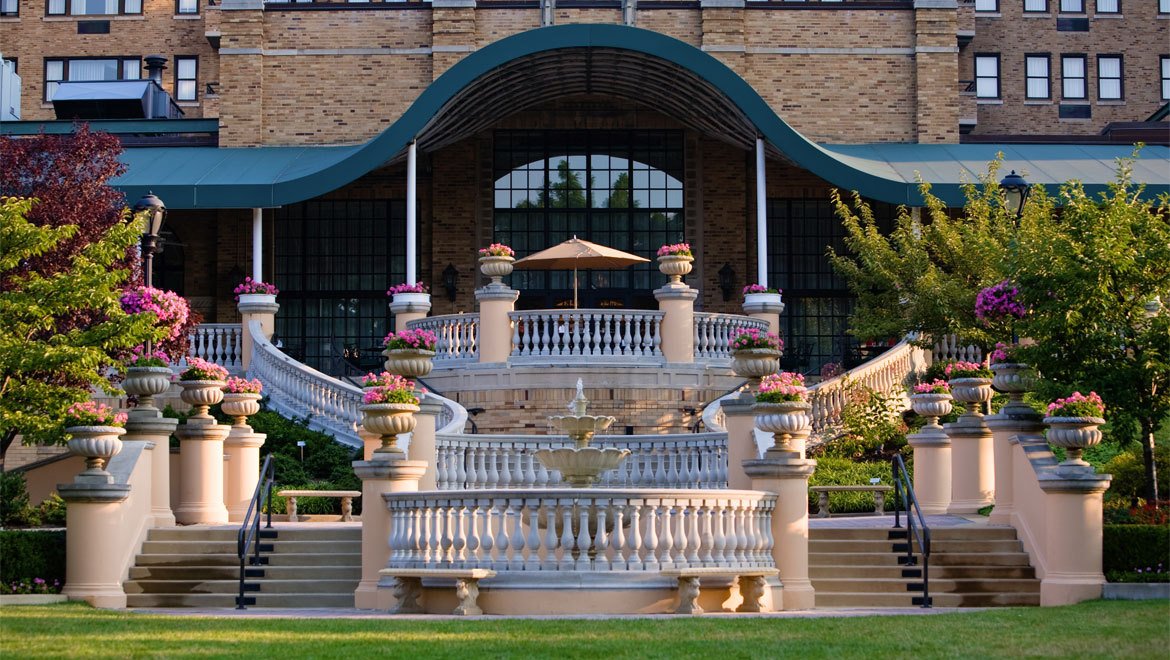 a building with a fountain and a lawn