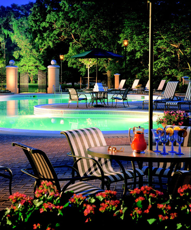 a pool with a table and chairs