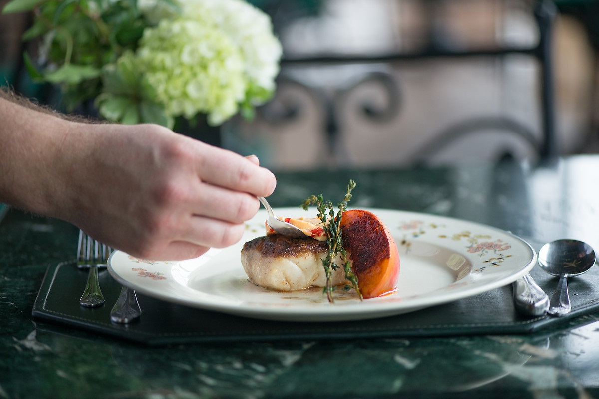 a person eating food on a plate