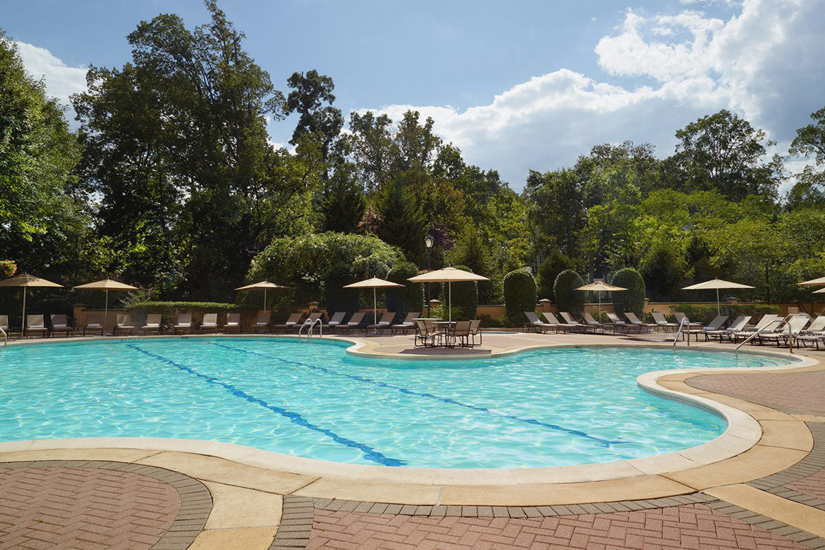 a pool with chairs and umbrellas
