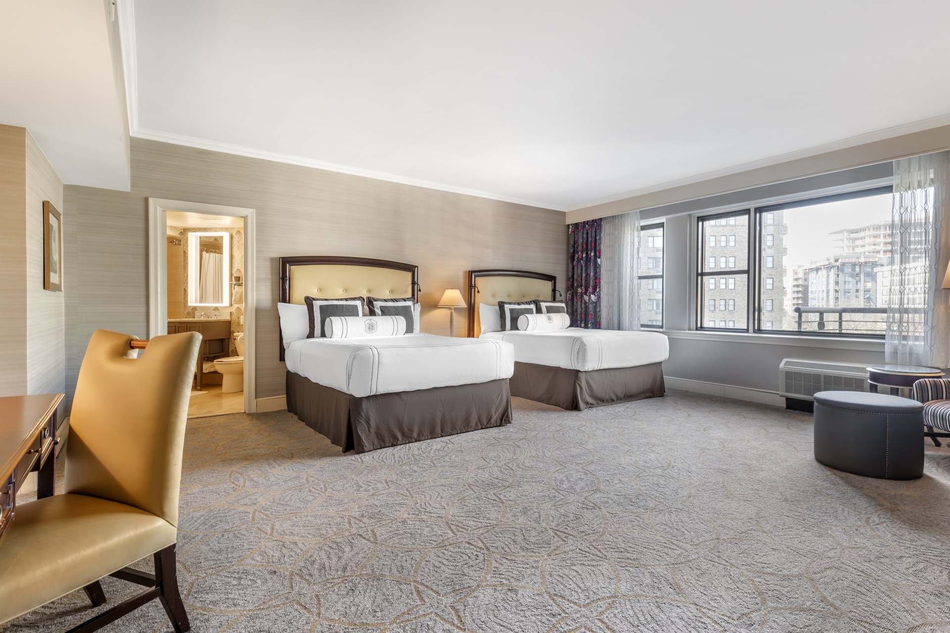 a room with two beds and a chair
