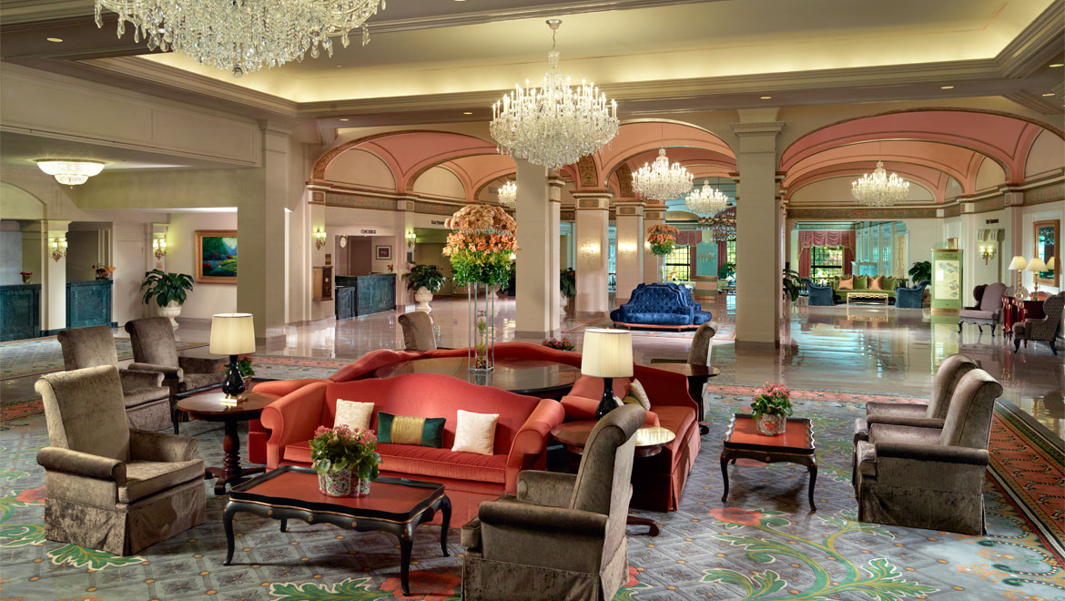 a large lobby with a large couch and chandelier
