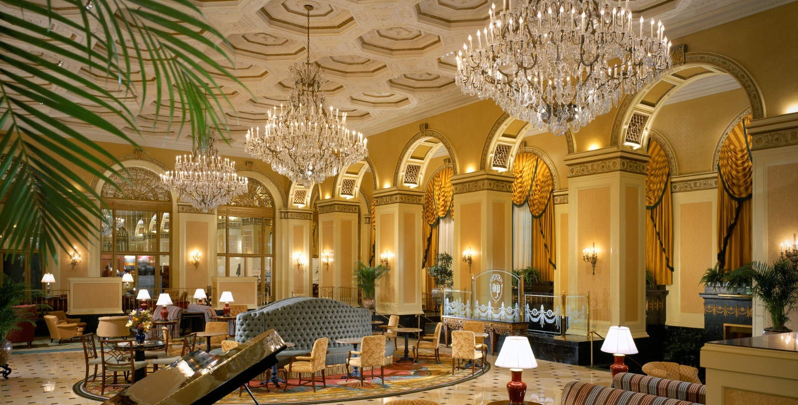 a large room with chandeliers and a piano