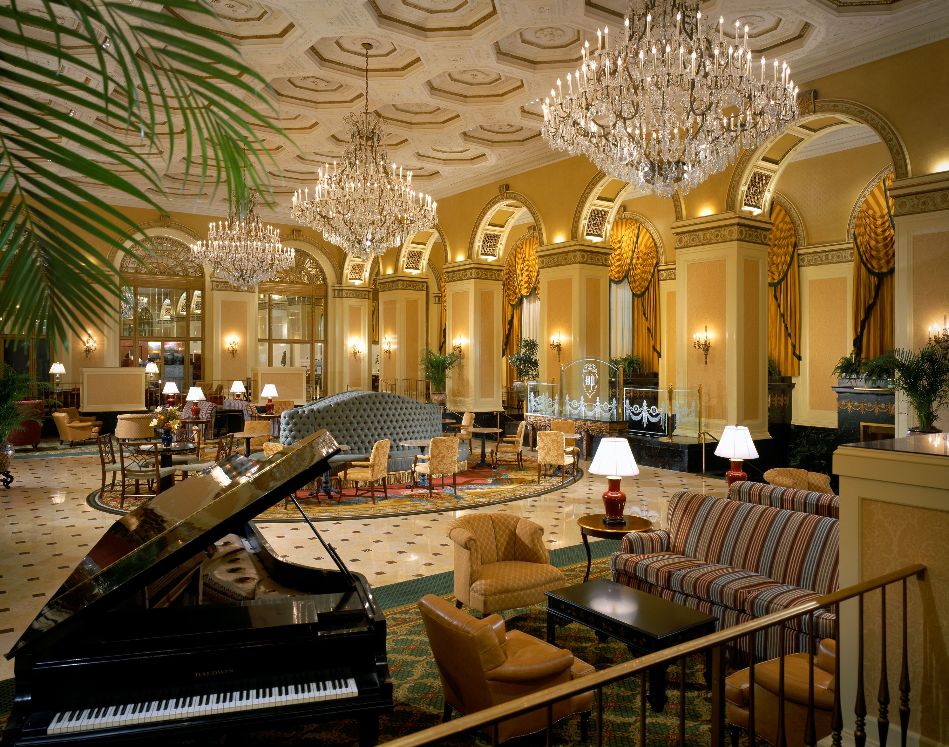 a room with chandeliers and piano
