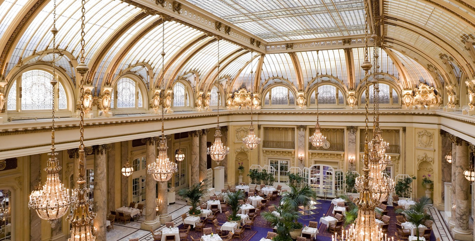 a room with tables and chandeliers