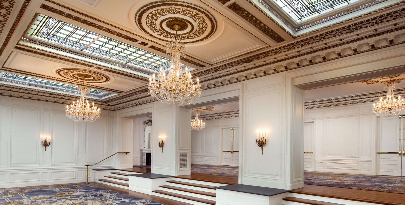 a large room with chandeliers and steps